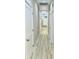 A bright hallway features light hardwood floors, neutral walls, and white doors at 1034 Weeks Lane, Round O, SC 29474