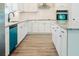 Modern kitchen with white cabinets, granite counters, and teal dishwasher at 1034 Weeks Lane, Round O, SC 29474