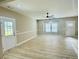 A spacious living room features light hardwood floors, neutral walls, two exterior doors and a large window at 1034 Weeks Lane, Round O, SC 29474