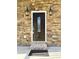 Elegant dark brown front door with glass accents and stone surround at 104 Del Ray Dr, Walterboro, SC 29488