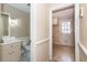 Small bathroom with toilet, sink, and access to laundry room at 108 Fairway Dr, Summerville, SC 29483