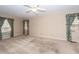 Spacious carpeted bedroom with multiple windows and curtains at 108 Fairway Dr, Summerville, SC 29483
