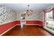 Dining room with hardwood floors, floral wallpaper, and chandelier at 108 Fairway Dr, Summerville, SC 29483