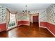 Bright dining room with hardwood floors, floral wallpaper, and chandelier at 108 Fairway Dr, Summerville, SC 29483