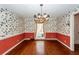 Dining room with hardwood floors, floral wallpaper and chandelier at 108 Fairway Dr, Summerville, SC 29483