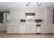 White kitchen cabinets, tile floor, and built in appliances at 108 Fairway Dr, Summerville, SC 29483