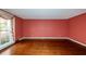 Hardwood floor living room with red walls and large window at 108 Fairway Dr, Summerville, SC 29483
