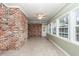 Bright sunroom with tile floor, brick wall, and multiple windows at 108 Fairway Dr, Summerville, SC 29483