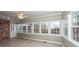 Bright sunroom with tile floor, brick wall, and multiple windows at 108 Fairway Dr, Summerville, SC 29483