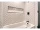 Bathroom with white herringbone tile and a tub at 1111 Barrett Rd, Charleston, SC 29407