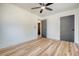 Bedroom with wood flooring, ceiling fan, and gray door at 1111 Barrett Rd, Charleston, SC 29407