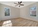 Well-lit bedroom with hardwood floors and two windows at 1111 Barrett Rd, Charleston, SC 29407