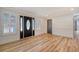 Light and airy foyer with hardwood floors and black doors at 1111 Barrett Rd, Charleston, SC 29407