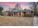 Brick ranch house with covered porch and landscaped yard at 1111 Barrett Rd, Charleston, SC 29407