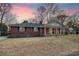 Brick ranch house with a covered porch and landscaped yard at 1111 Barrett Rd, Charleston, SC 29407