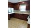 Kitchen features wood cabinets and patterned flooring at 206 Dora Dr, Saint George, SC 29477