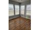 Sunroom with hardwood floors and multiple windows at 206 Dora Dr, Saint George, SC 29477