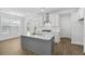 Bright kitchen with white cabinets, marble countertops, and a large island at 2129 Blue Bayou Blvd, Johns Island, SC 29455