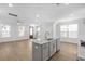 Open concept kitchen features a large island with marble countertops and gold fixtures at 2129 Blue Bayou Blvd, Johns Island, SC 29455