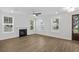 Bright living room with hardwood floors, fireplace, and plenty of natural light at 2129 Blue Bayou Blvd, Johns Island, SC 29455