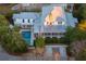 White two-story home with a metal roof, pool, and landscaped yard at 222 Haddrell St, Mount Pleasant, SC 29464