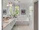 Elegant bathroom with double vanity, soaking tub, and walk-in shower at 222 Haddrell St, Mount Pleasant, SC 29464
