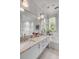 Bright bathroom boasts double sinks, marble countertop, and large mirror at 222 Haddrell St, Mount Pleasant, SC 29464