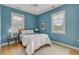 Light filled bedroom with wood floors, a full bed, and blue walls at 222 Haddrell St, Mount Pleasant, SC 29464
