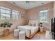 Charming bedroom with a queen bed and calming pink walls at 222 Haddrell St, Mount Pleasant, SC 29464