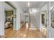 Bright entryway with hardwood floors, white shiplap walls, and staircase at 222 Haddrell St, Mount Pleasant, SC 29464