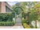 Private garden gate with lush greenery and brick pathway at 222 Haddrell St, Mount Pleasant, SC 29464