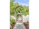 Charming brick pathway leads through a lush garden gate at 222 Haddrell St, Mount Pleasant, SC 29464