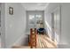Light-filled hallway with hardwood floors and built-in seating area at 222 Haddrell St, Mount Pleasant, SC 29464