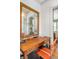 Desk area with a vintage mirror and an orange chair at 222 Haddrell St, Mount Pleasant, SC 29464