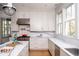 Modern kitchen with marble countertops, stainless steel appliances, and white cabinetry at 222 Haddrell St, Mount Pleasant, SC 29464