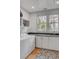 Well-lit laundry room with white cabinets and two large windows at 222 Haddrell St, Mount Pleasant, SC 29464