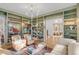 Spacious library featuring built-in shelves, a view into the dining room, and hardwood floors at 222 Haddrell St, Mount Pleasant, SC 29464
