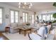 Open concept living room with large windows and a sectional sofa at 222 Haddrell St, Mount Pleasant, SC 29464