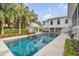 Inviting swimming pool surrounded by lush landscaping and a white home at 222 Haddrell St, Mount Pleasant, SC 29464