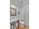Powder room with white pedestal sink and wooden framed mirror at 222 Haddrell St, Mount Pleasant, SC 29464