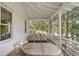 Relaxing screened porch with seating area and view of trees at 222 Haddrell St, Mount Pleasant, SC 29464