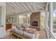 Spacious screened porch with a fireplace and comfortable seating at 222 Haddrell St, Mount Pleasant, SC 29464