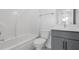 Main bathroom with a tub, toilet and gray vanity at 2253 Blue Bayou Blvd, Johns Island, SC 29455