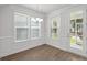 Bright dining room with hardwood floors and a view to the backyard through French doors at 2253 Blue Bayou Blvd, Johns Island, SC 29455