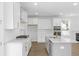 Modern white kitchen with marble countertops, gold accents, and stainless steel appliances at 2253 Blue Bayou Blvd, Johns Island, SC 29455