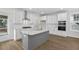 White kitchen with gray island, stainless steel appliances, and hardwood floors at 2253 Blue Bayou Blvd, Johns Island, SC 29455