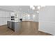 Bright and airy living room with hardwood floors and a fireplace, open to the kitchen at 2253 Blue Bayou Blvd, Johns Island, SC 29455