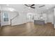 Open concept living room, kitchen, and staircase with hardwood floors at 2253 Blue Bayou Blvd, Johns Island, SC 29455