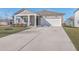 Two-car garage and front yard with a gray house and white trim at 286 W Bradford Pointe Dr, Summerville, SC 29486