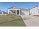 Gray house with white columns, a white garage door, and a nicely landscaped front yard at 286 W Bradford Pointe Dr, Summerville, SC 29486